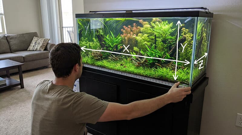 How to measure aquarium dimensions - diagram showing length (X axis left to right), width (Y axis front to back), and height (Z axis bottom to top) with measuring tape and arrows indicating each dimension on a planted aquarium tank